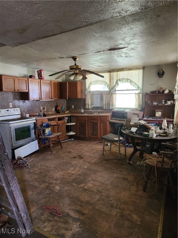 kitchen featuring ceiling fan, a textured ceiling, backsplash, and white electric stove