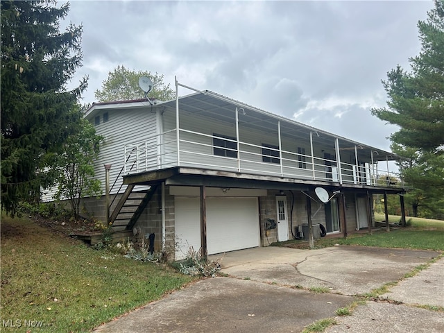 rear view of property featuring a garage