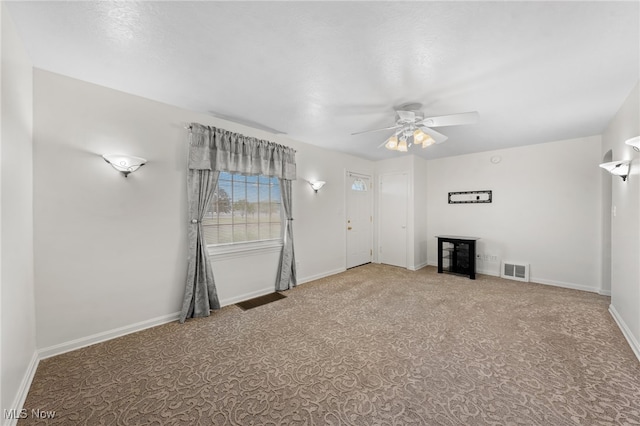 unfurnished living room with carpet flooring and ceiling fan