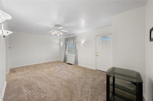 carpeted spare room with ceiling fan