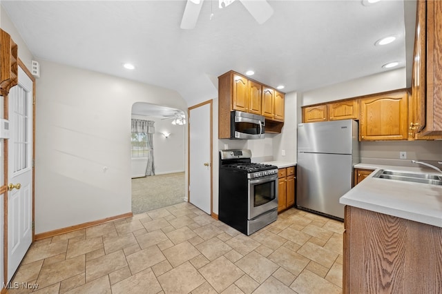 kitchen with sink, ceiling fan, and stainless steel appliances