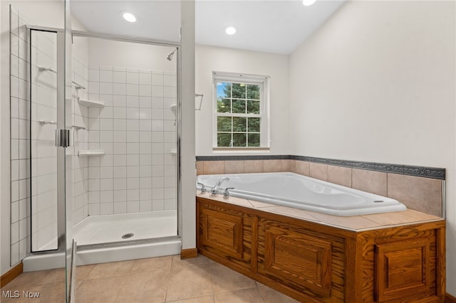 bathroom with tile patterned flooring and independent shower and bath