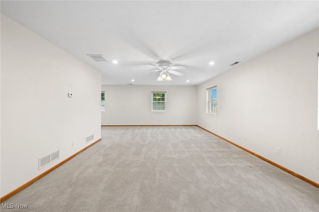 unfurnished room featuring ceiling fan and light colored carpet