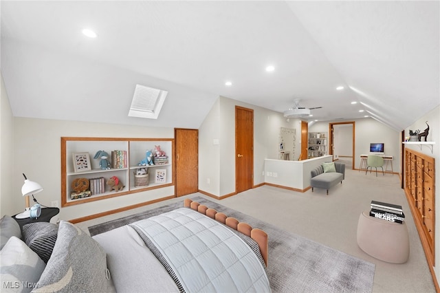 carpeted bedroom featuring lofted ceiling with skylight