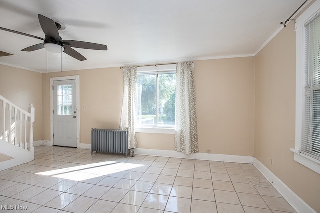 entryway with radiator heating unit, ceiling fan, plenty of natural light, and crown molding