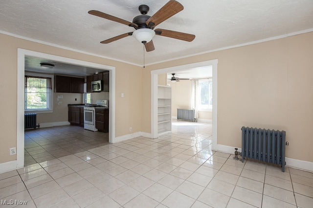 unfurnished living room with light tile patterned flooring, ceiling fan, radiator heating unit, and plenty of natural light