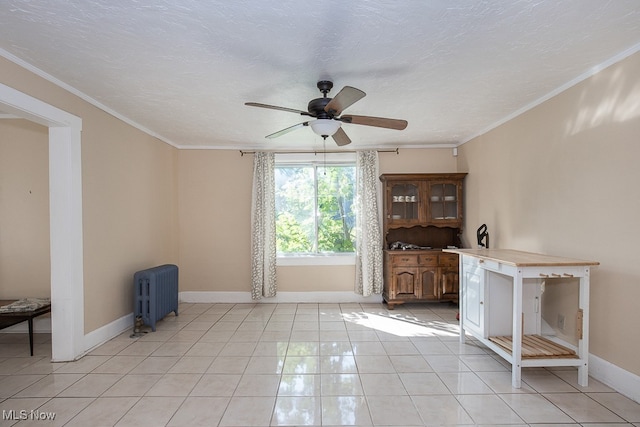 interior space featuring a textured ceiling, light tile patterned flooring, radiator, crown molding, and ceiling fan