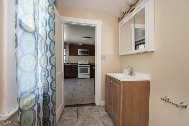 bathroom with tile patterned flooring and vanity