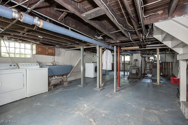 basement with sink and washing machine and dryer