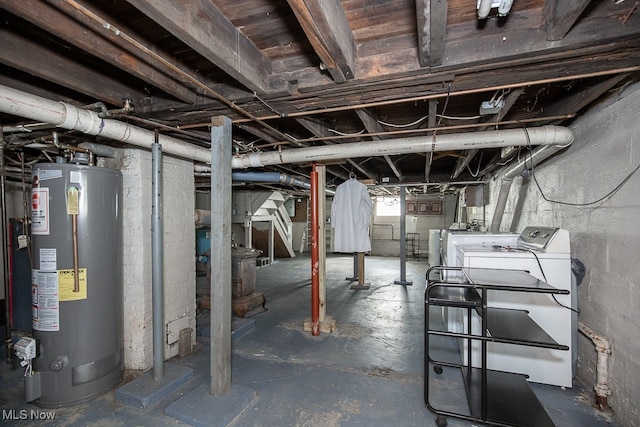 basement featuring water heater and washer and dryer