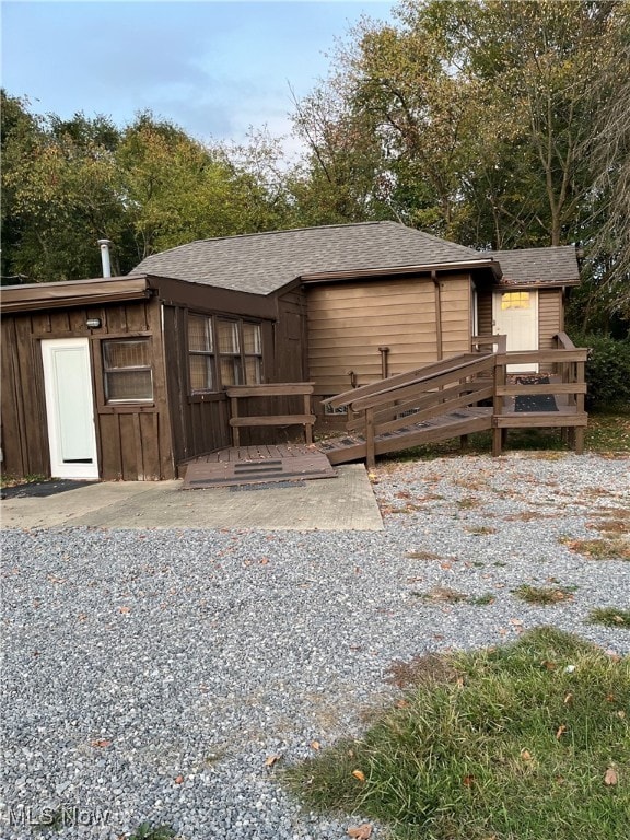 back of property featuring a shed