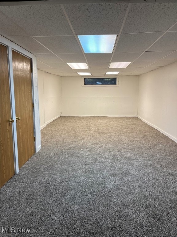 basement with a drop ceiling and carpet flooring