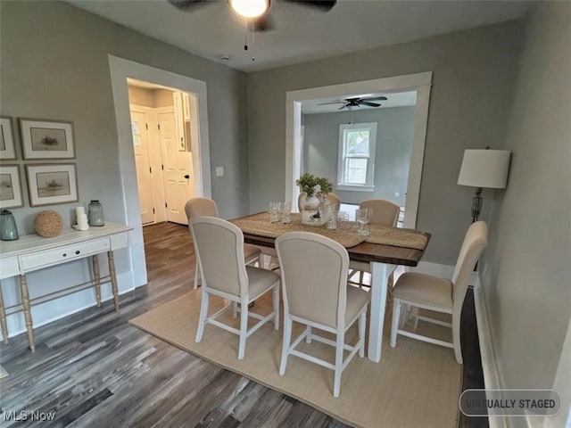 dining space with dark wood-type flooring and ceiling fan