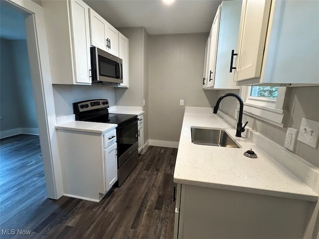 kitchen featuring sink, dark wood-type flooring, stainless steel appliances, and white cabinets