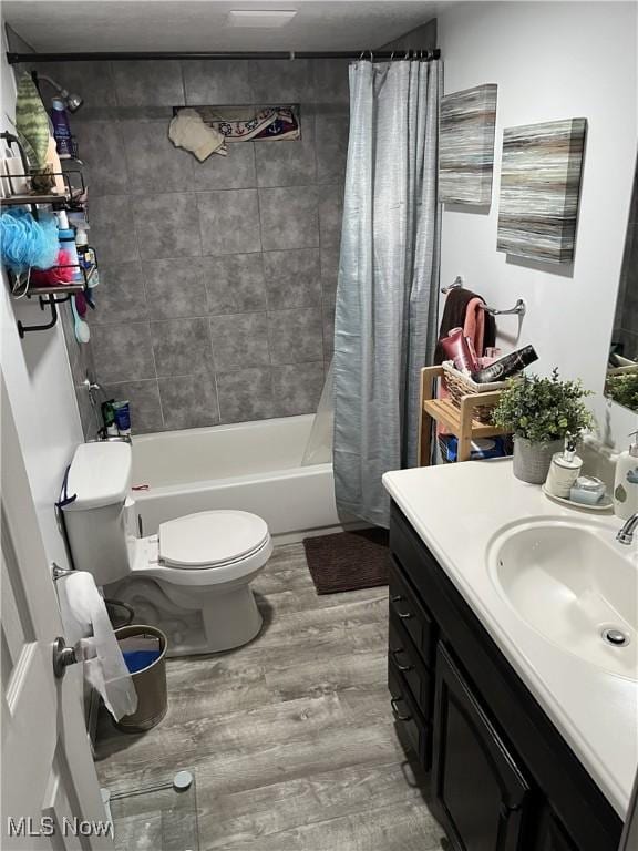 9151 Mentor Ave Unit A14, Mentor, OH 44060 - bathroom with toilet, shower / bathtub combination with curtain, vanity, and wood finished floors