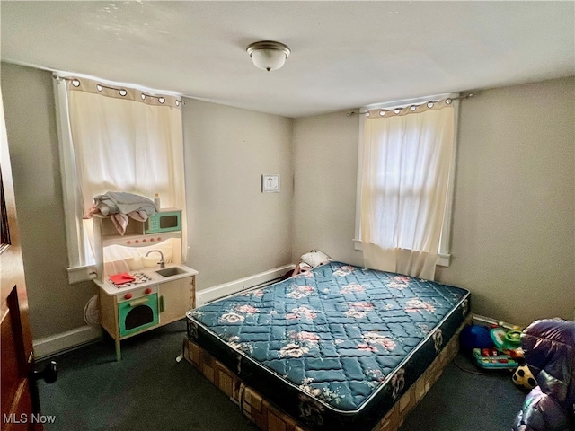 bedroom featuring dark carpet