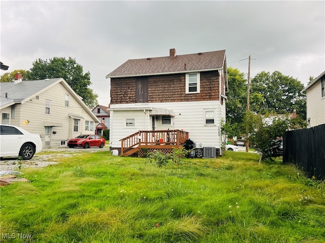 rear view of property with central AC unit