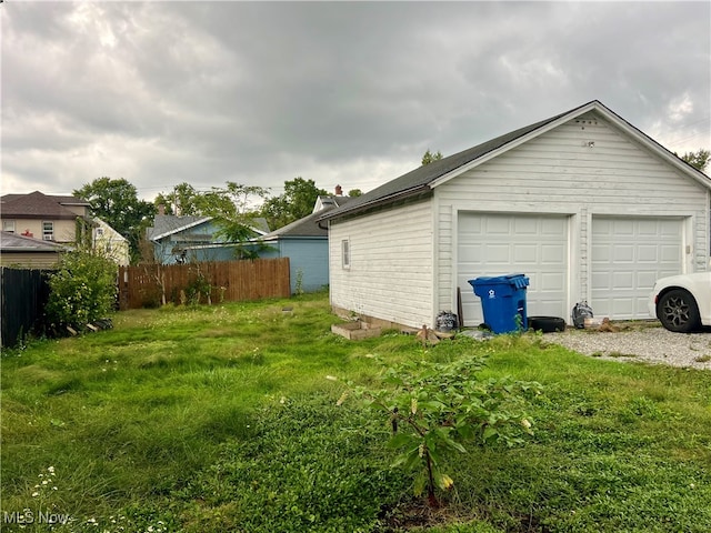 garage featuring a lawn