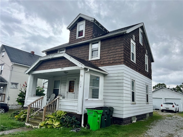 view of front of home featuring a garage and an outbuilding