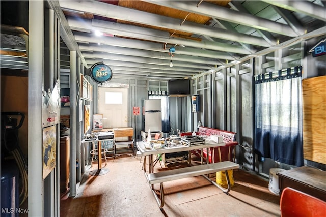 basement with stainless steel refrigerator