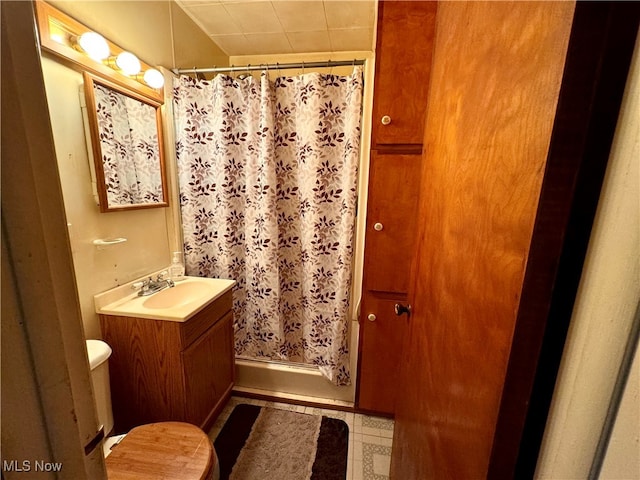 bathroom featuring tile patterned flooring, vanity, toilet, and a shower with shower curtain