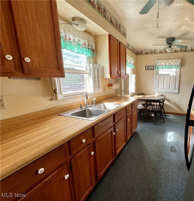 kitchen with refrigerator, sink, and ceiling fan