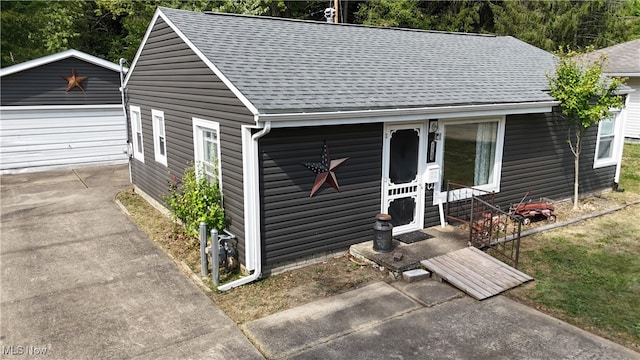 bungalow-style house with an outdoor structure and a garage