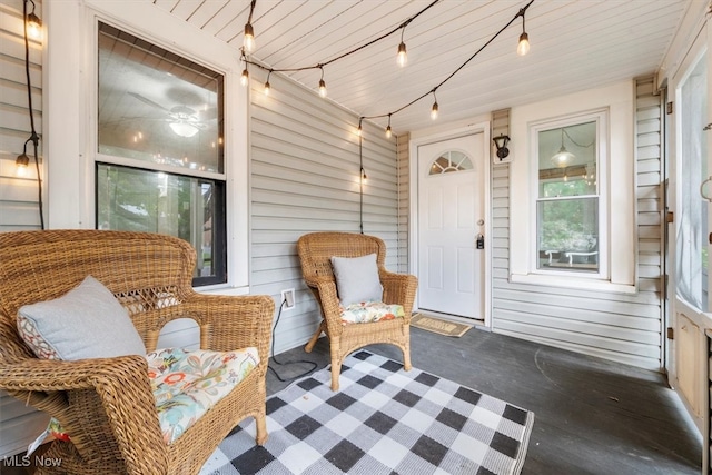 sunroom featuring ceiling fan and wood ceiling