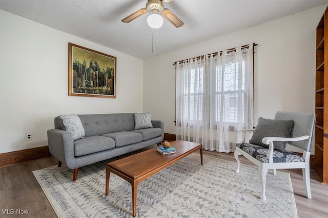 living room with ceiling fan and light hardwood / wood-style flooring