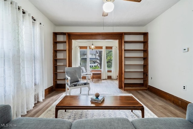 living room with ceiling fan and hardwood / wood-style floors