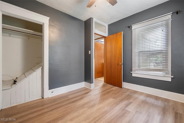 unfurnished bedroom featuring a closet, light wood-type flooring, and ceiling fan