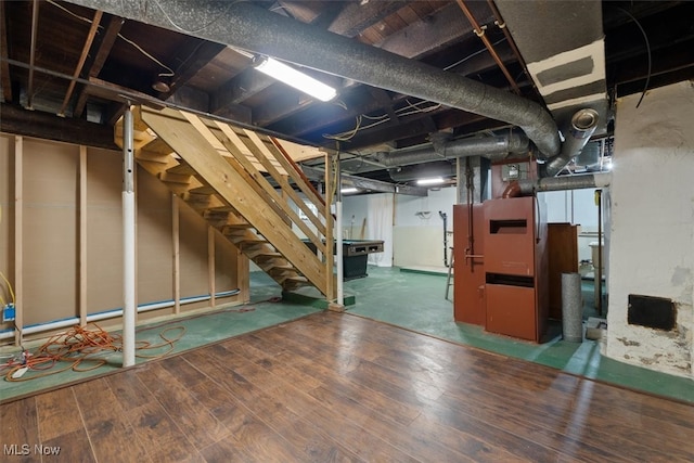 basement featuring a fireplace and dark hardwood / wood-style floors