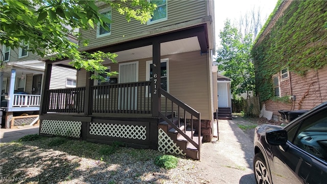 back of property with covered porch