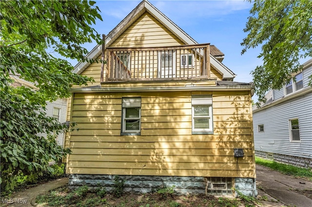 view of side of property with a balcony