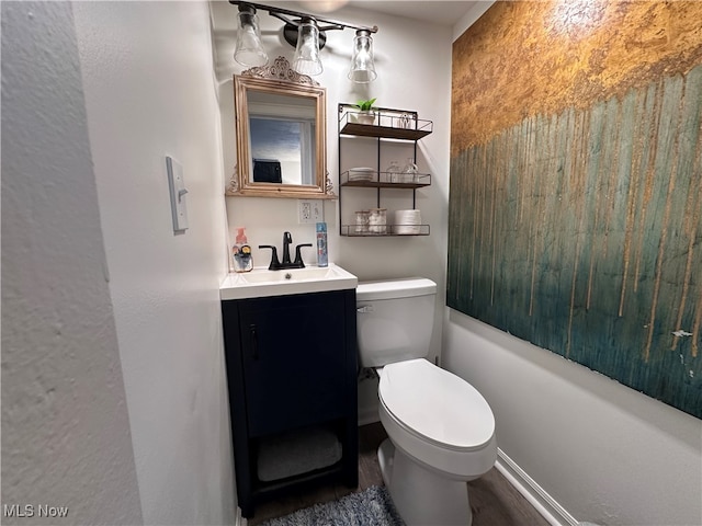 bathroom with hardwood / wood-style flooring, a shower, vanity, and toilet