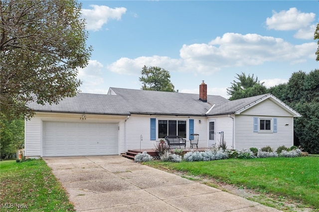 single story home featuring a garage and a front lawn