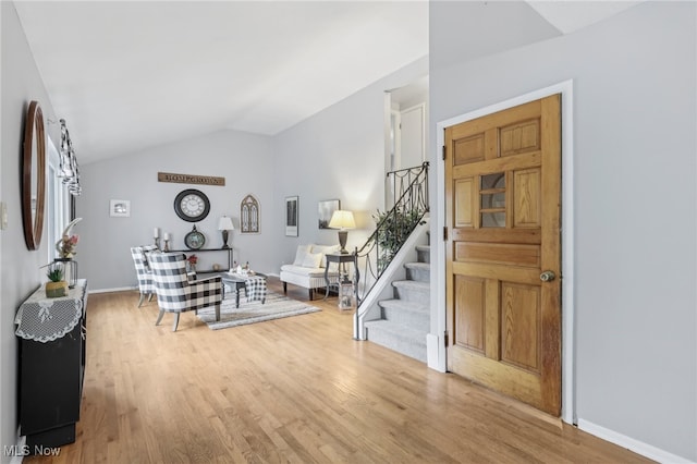 entryway with vaulted ceiling and hardwood / wood-style floors