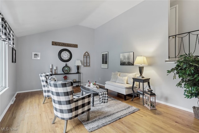 living room with wood-type flooring and vaulted ceiling