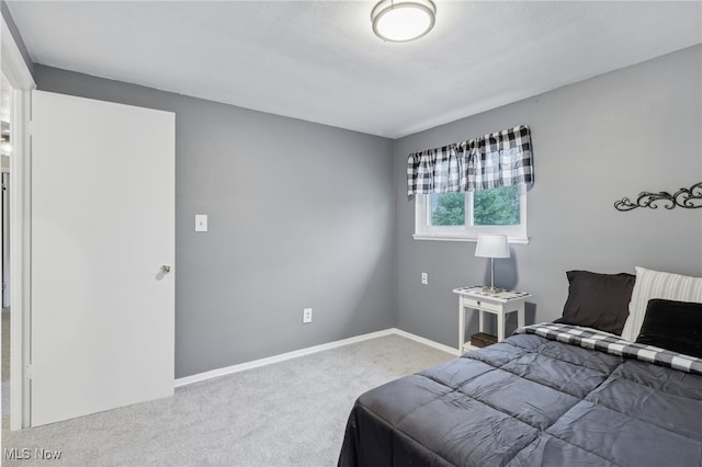 bedroom with light colored carpet