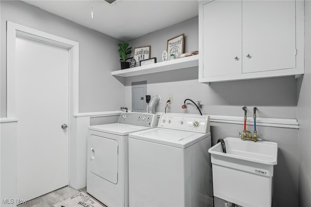 washroom featuring cabinets and independent washer and dryer