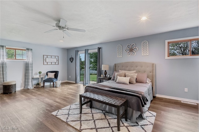 bedroom featuring ceiling fan, access to exterior, and hardwood / wood-style floors