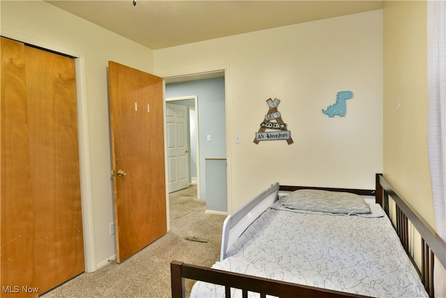 carpeted bedroom featuring a closet