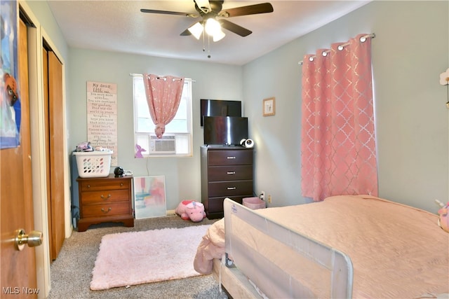 bedroom with carpet floors, cooling unit, ceiling fan, and a closet