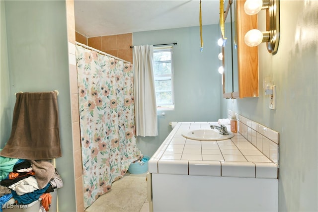 bathroom with tile patterned flooring, a shower with curtain, and vanity