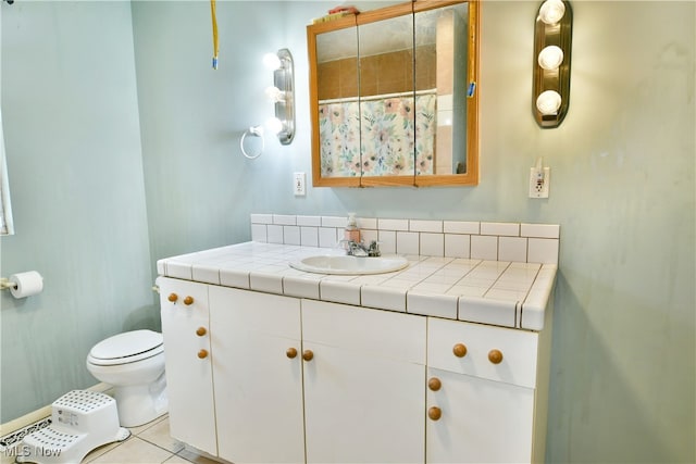 bathroom with tile patterned floors, vanity, and toilet