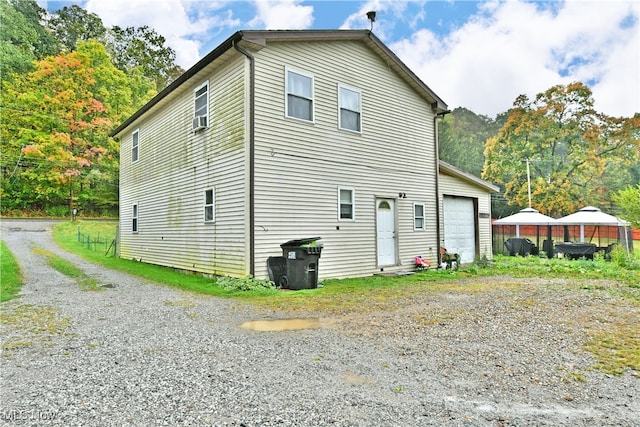 view of side of home featuring a garage