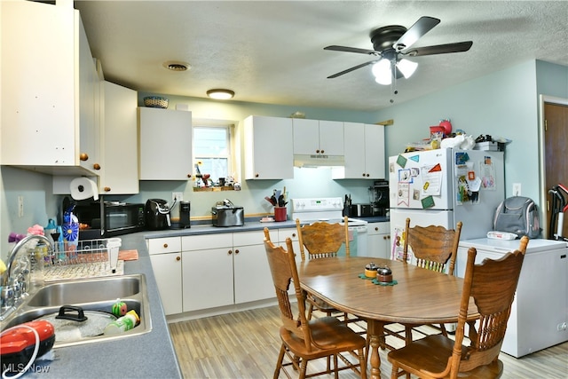 kitchen featuring white cabinets, white appliances, light wood-type flooring, ceiling fan, and sink