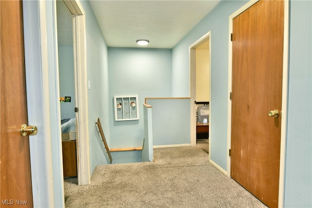 hall with light colored carpet