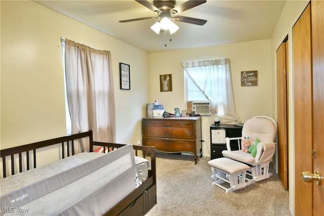 carpeted bedroom featuring cooling unit and ceiling fan