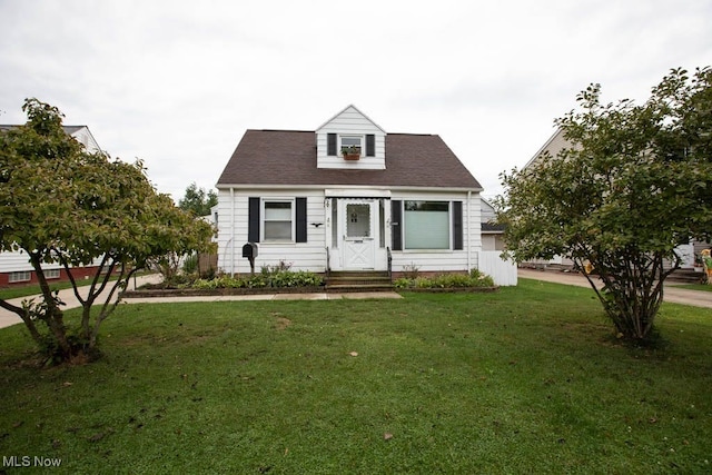 cape cod home with a front lawn